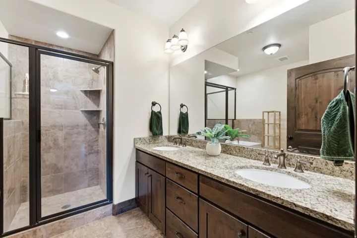 Double vanity with light granite countertops and undermount sinks