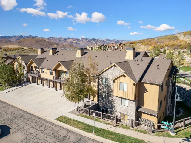 Multi-level townhome-style residences featuring stone and wood-look siding exteriors