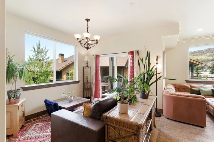 Spacious room with multiple large windows, a decorative chandelier, and a wood-finish window ledge