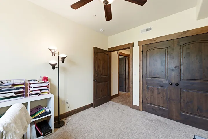 Interior room featuring light-colored walls and carpeted flooring