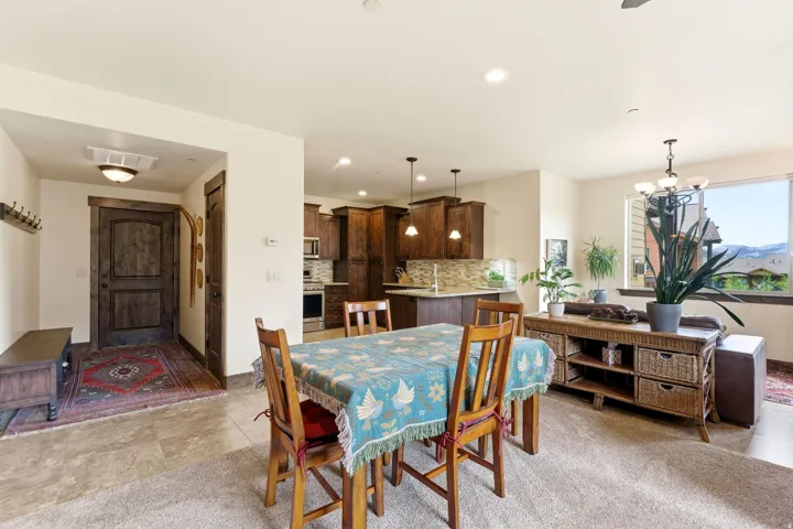 Open-concept living space featuring a dining area, kitchen, and entry