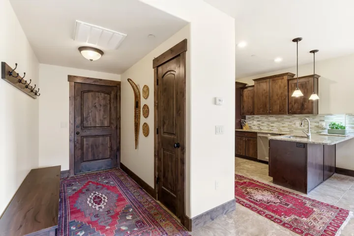Entryway featuring a built-in wood bench, dark wood door with matching trim, and an overhead flush mount light fixture