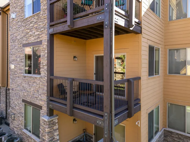 Multi-story exterior with stone veneer and horizontal siding