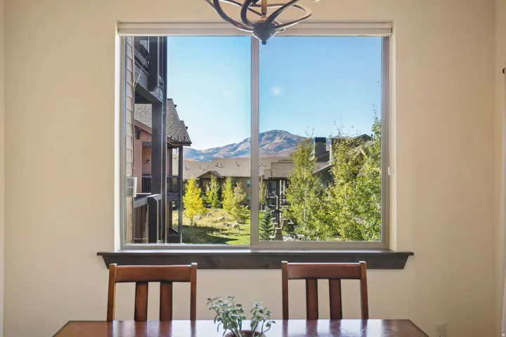 Expansive window framing mountain and community surroundings