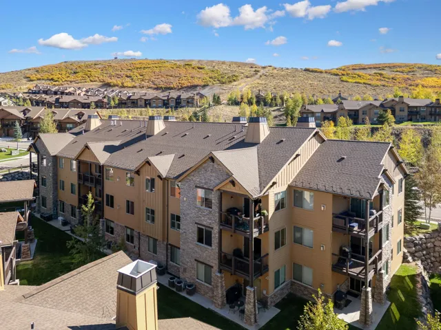 Multi-story building featuring natural stone and siding exterior