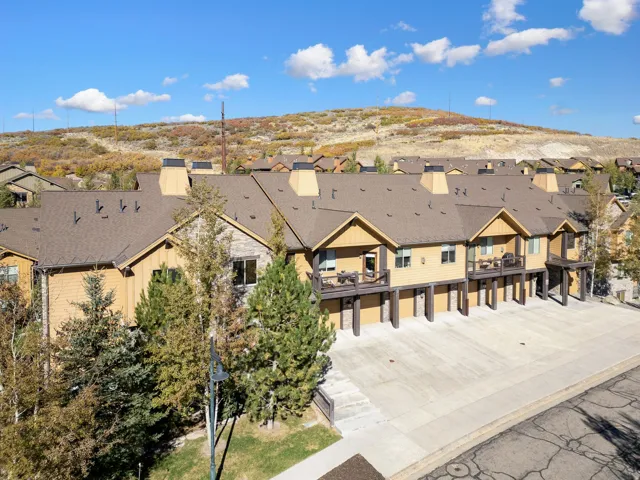Townhome-style residences featuring light brown siding and dark brown trim