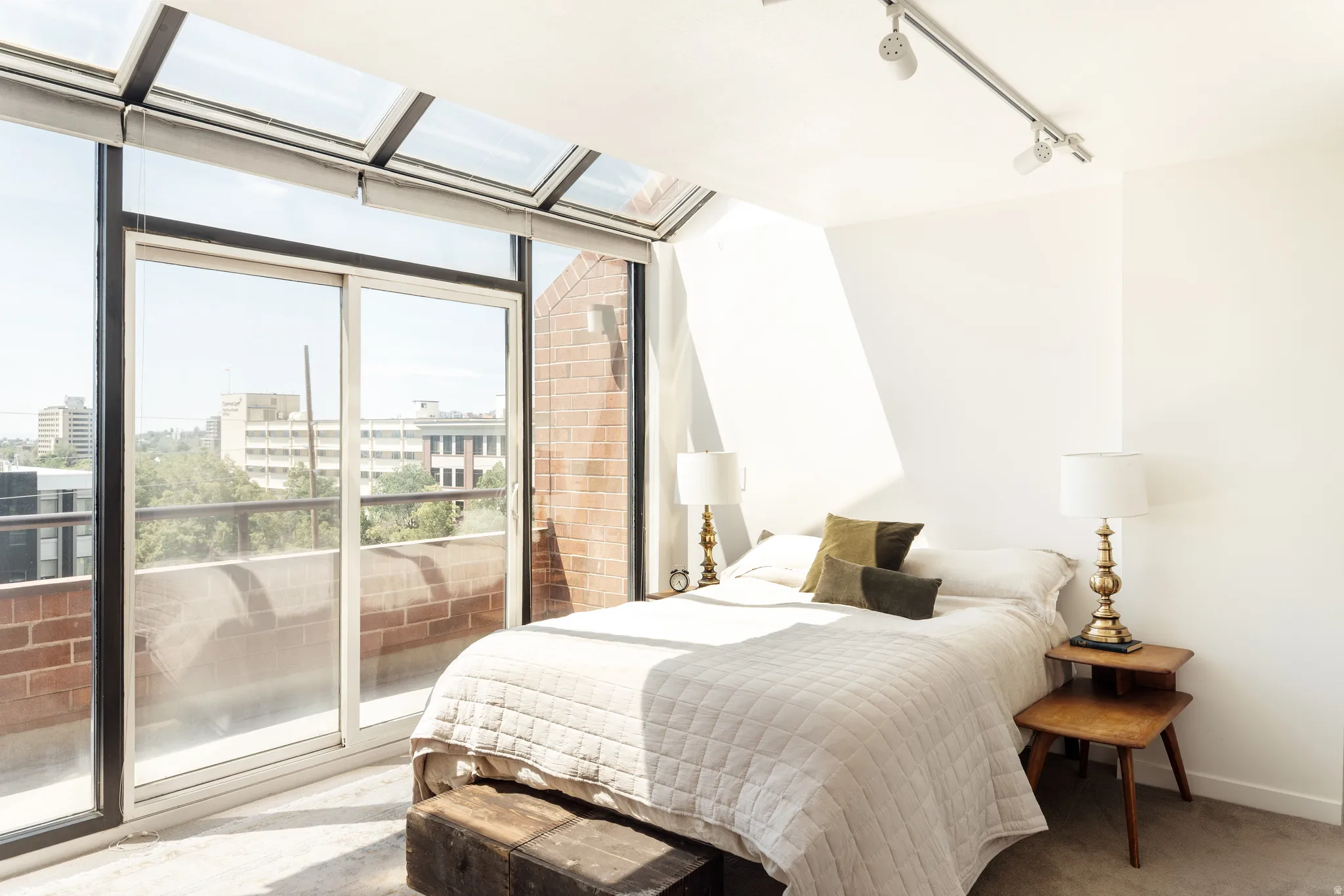Bedroom with floor-to-ceiling glass and integrated skylight