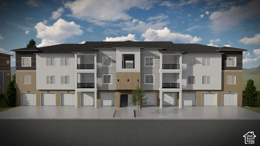 Multi-story townhome-style building with a dark shingle roof, light-toned siding, and stone veneer accents