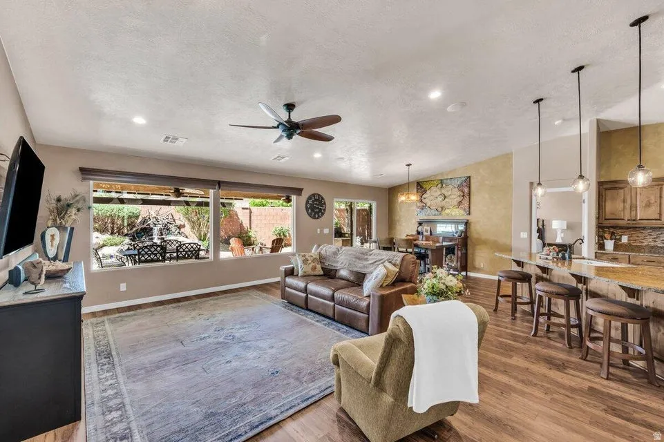 Open-concept interior featuring wood-finish flooring, recessed lighting, and a ceiling fan
