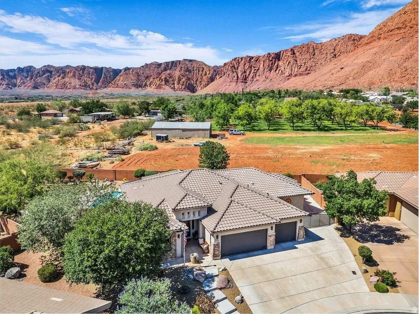 Property featuring a tile roof, an integrated two-car garage, and a concrete driveway