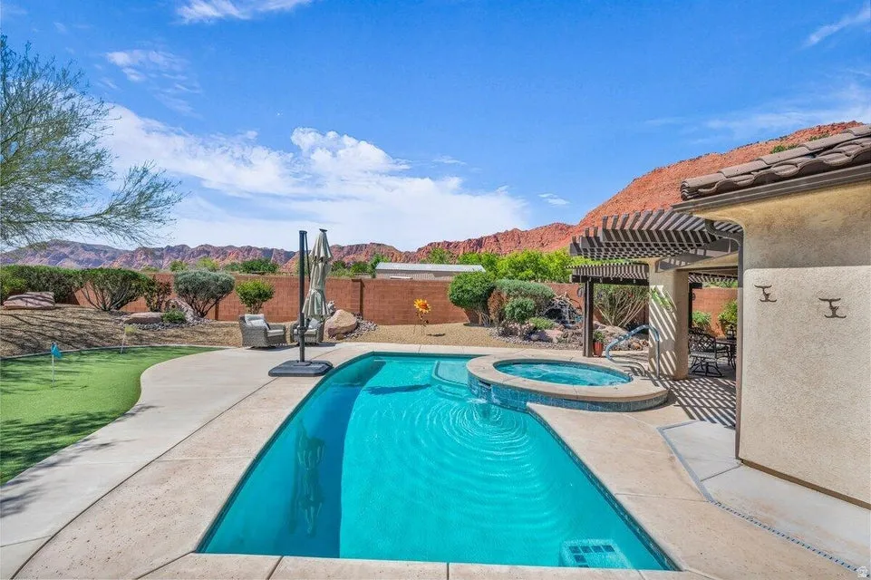 Sparkling outdoor pool and integrated spa with a spacious surrounding patio