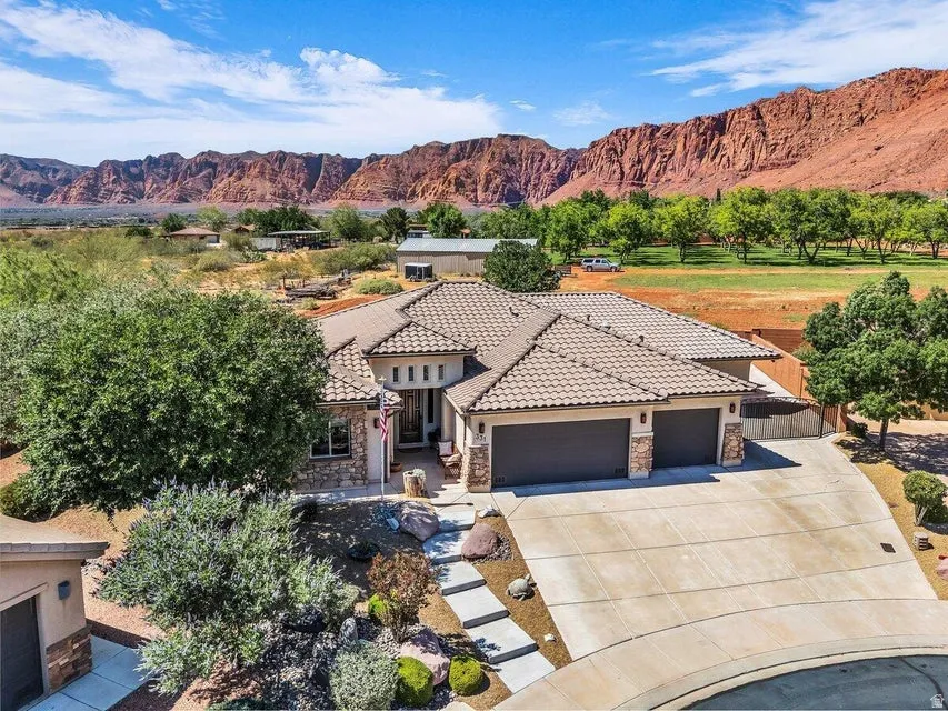 Single-story residence featuring a tile roof, stone and stucco exterior, and an attached two-car garage