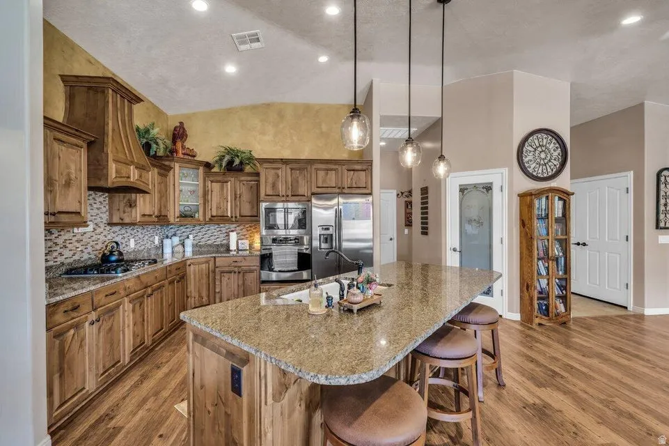 Kitchen featuring wood-finish cabinetry, granite countertops, and stainless steel appliances