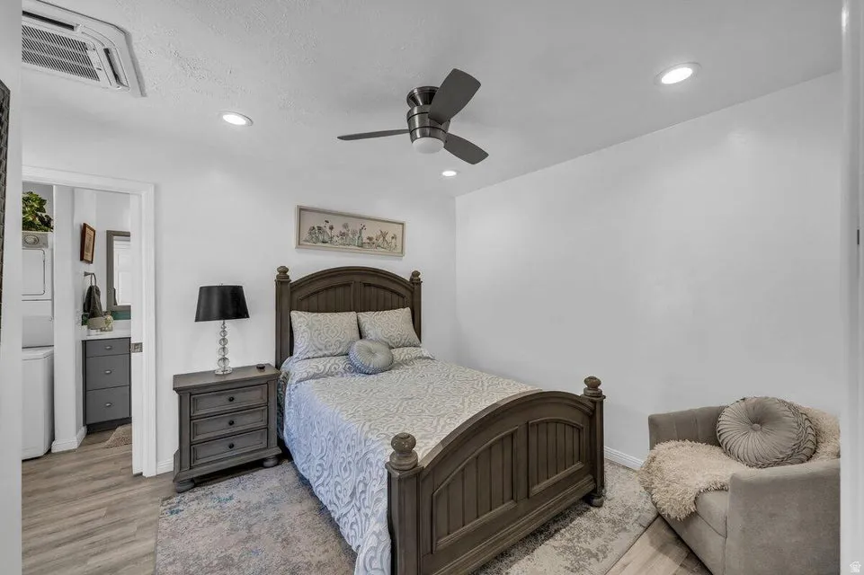 Bedroom featuring wood-finish flooring, recessed lighting, and a ceiling fan