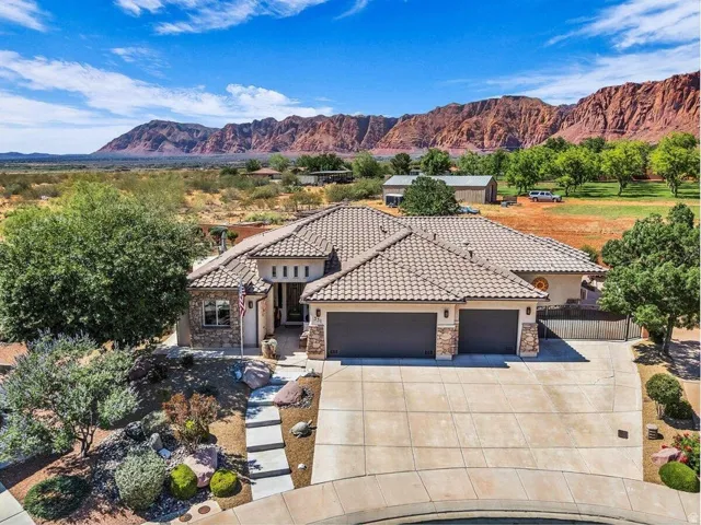 Expansive single-story residence with a tiled roof and stone veneer accents