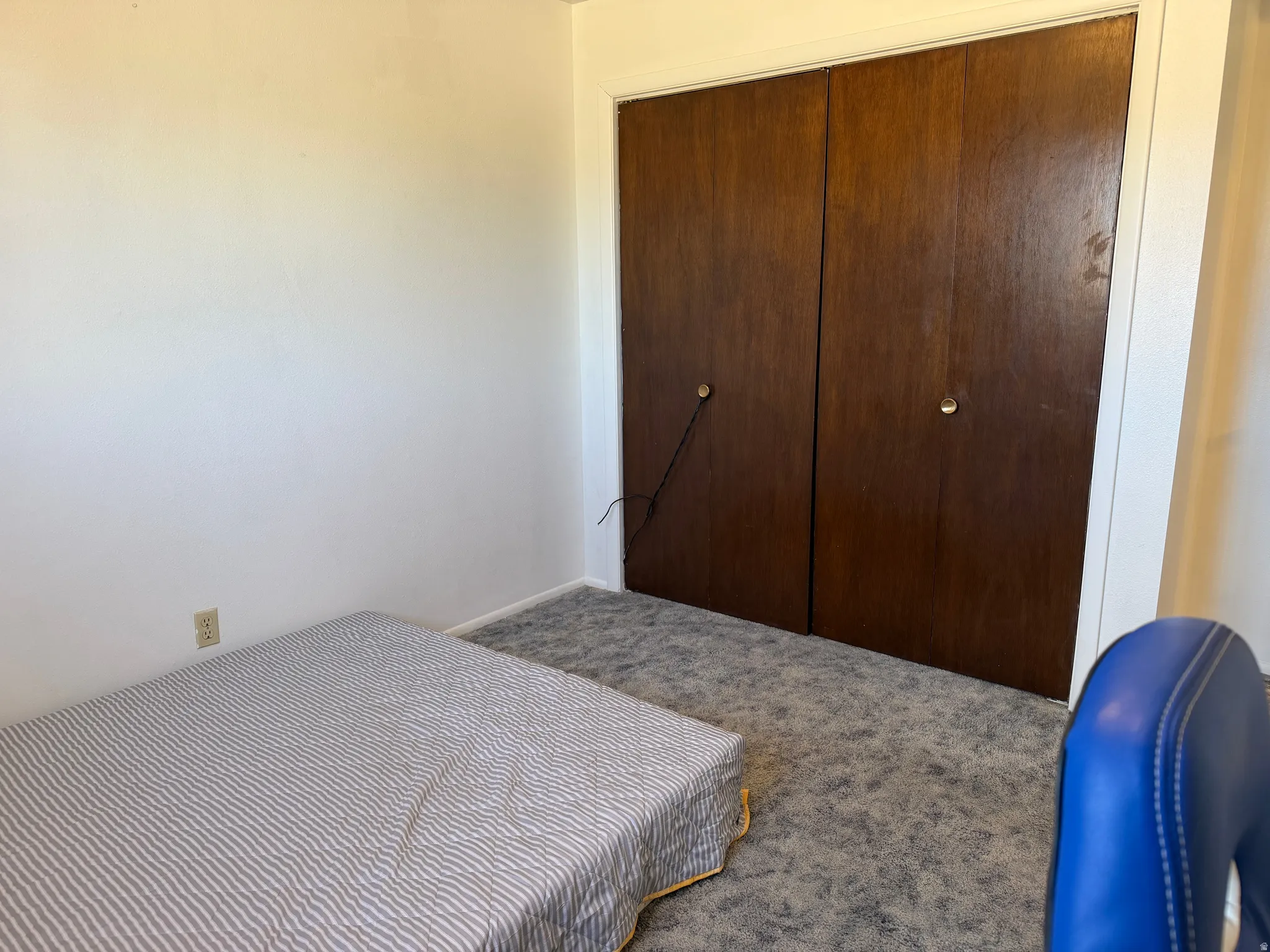 Bedroom featuring white walls and grey patterned carpeting