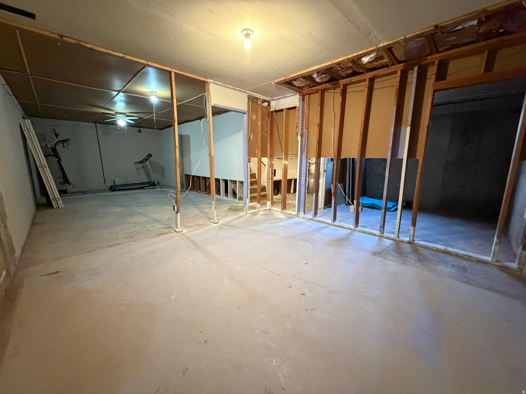 Unfinished basement space with exposed framing and concrete flooring, offering versatile customization potential