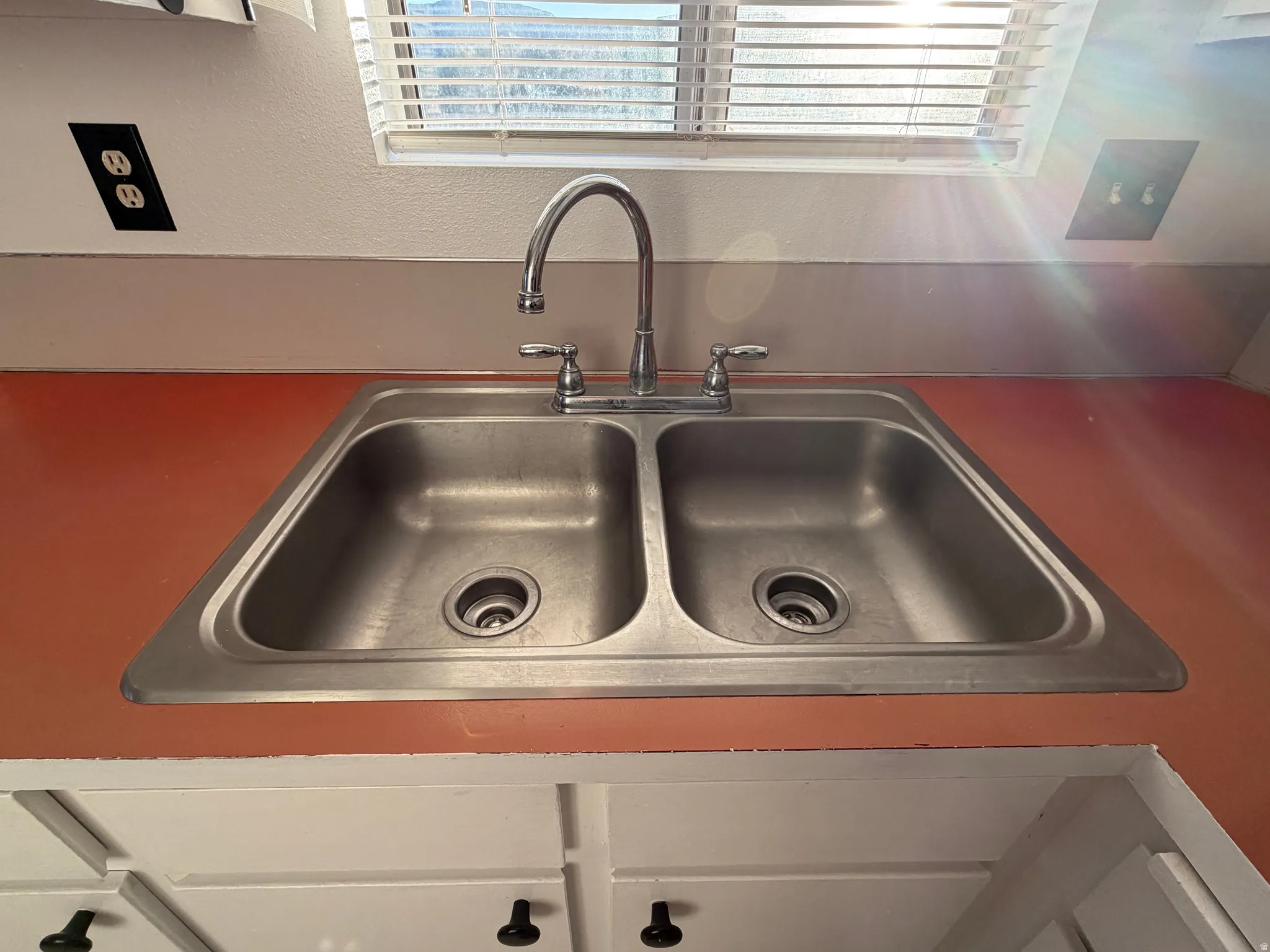 Double basin stainless steel sink with a chrome faucet