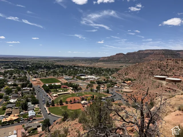 Expansive high-elevation panorama overlooking a community with residential areas and recreational fields