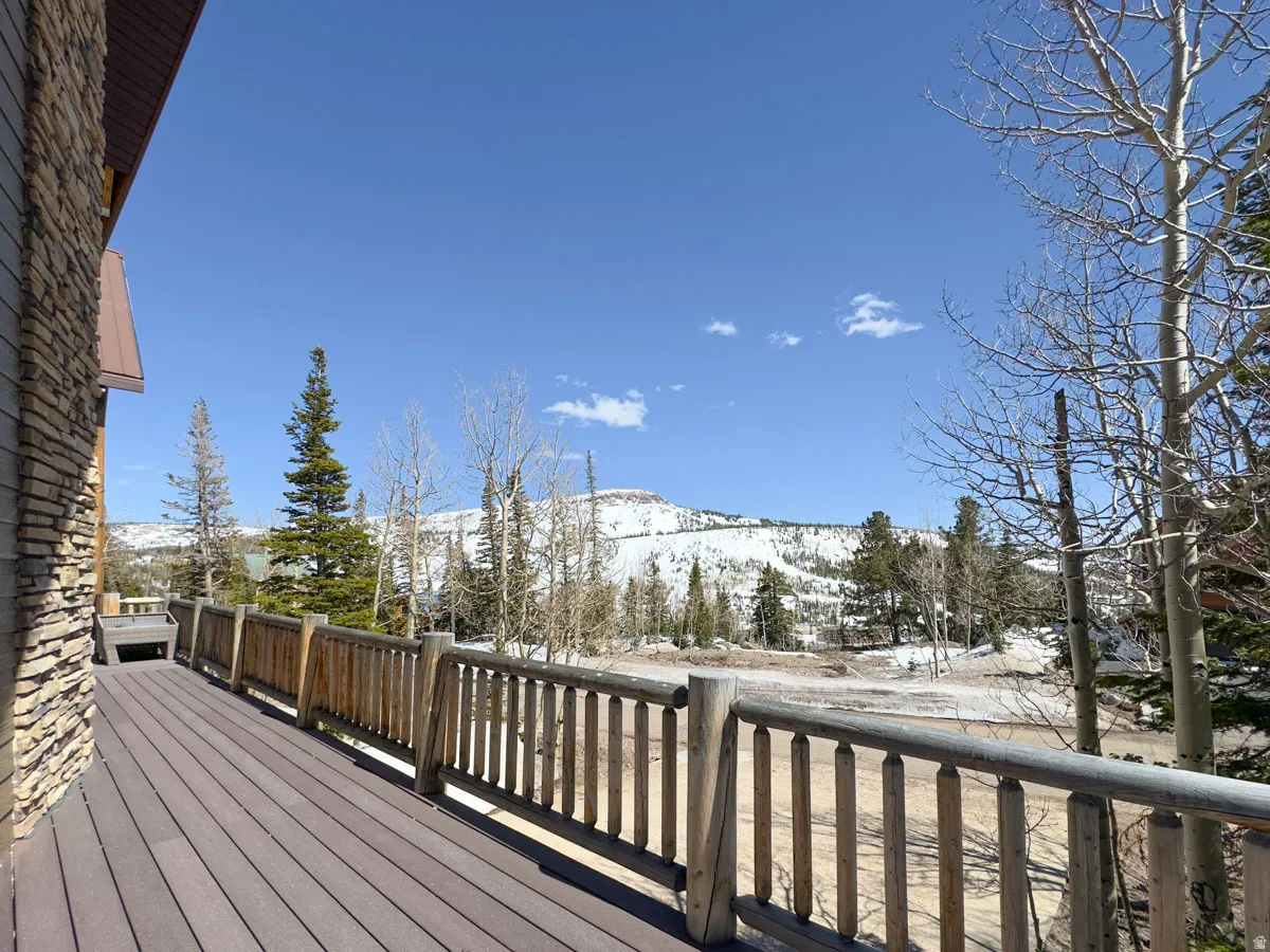 Spacious outdoor deck with composite decking and rustic wood railing