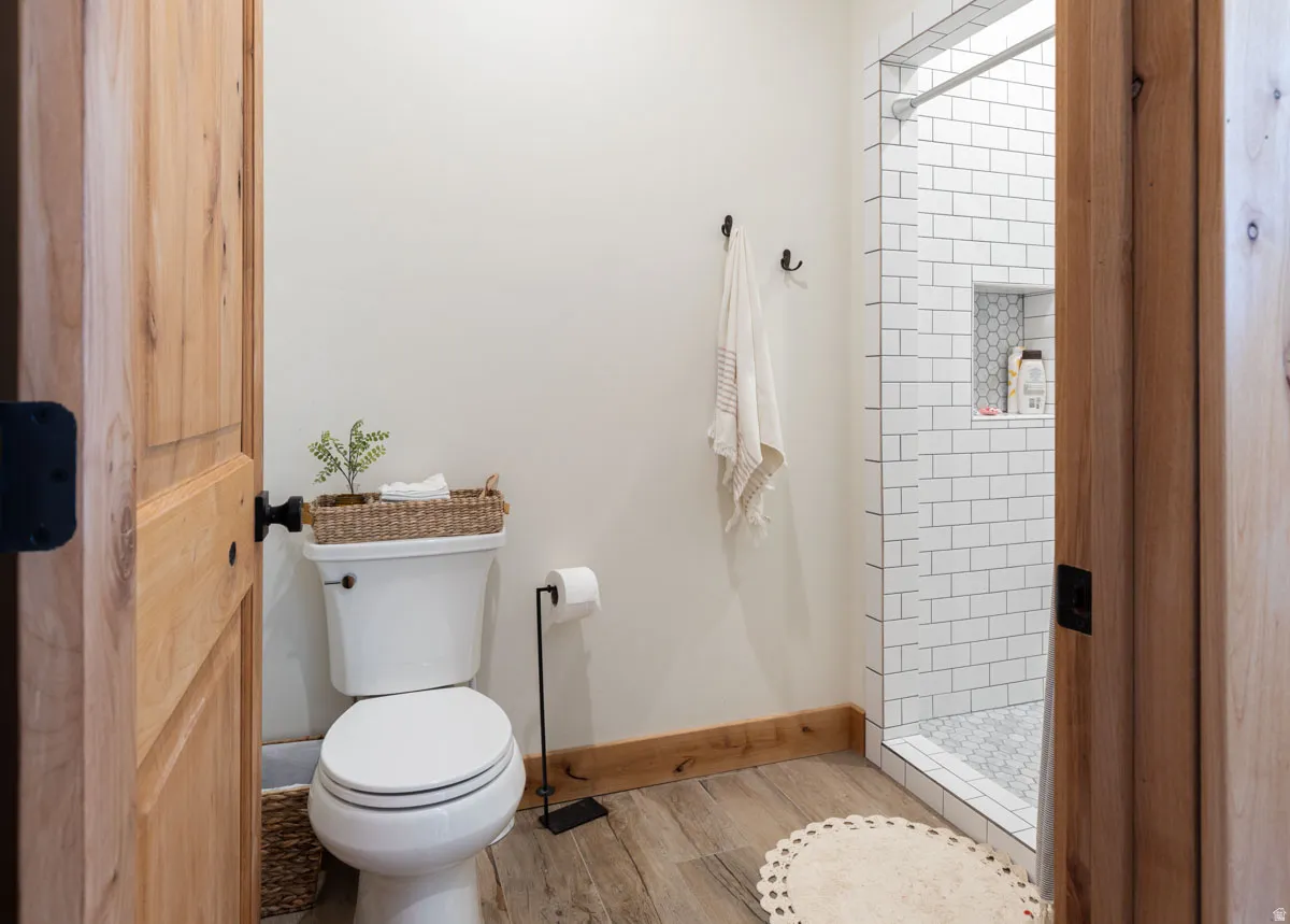Bathroom featuring wood-finish flooring and baseboards