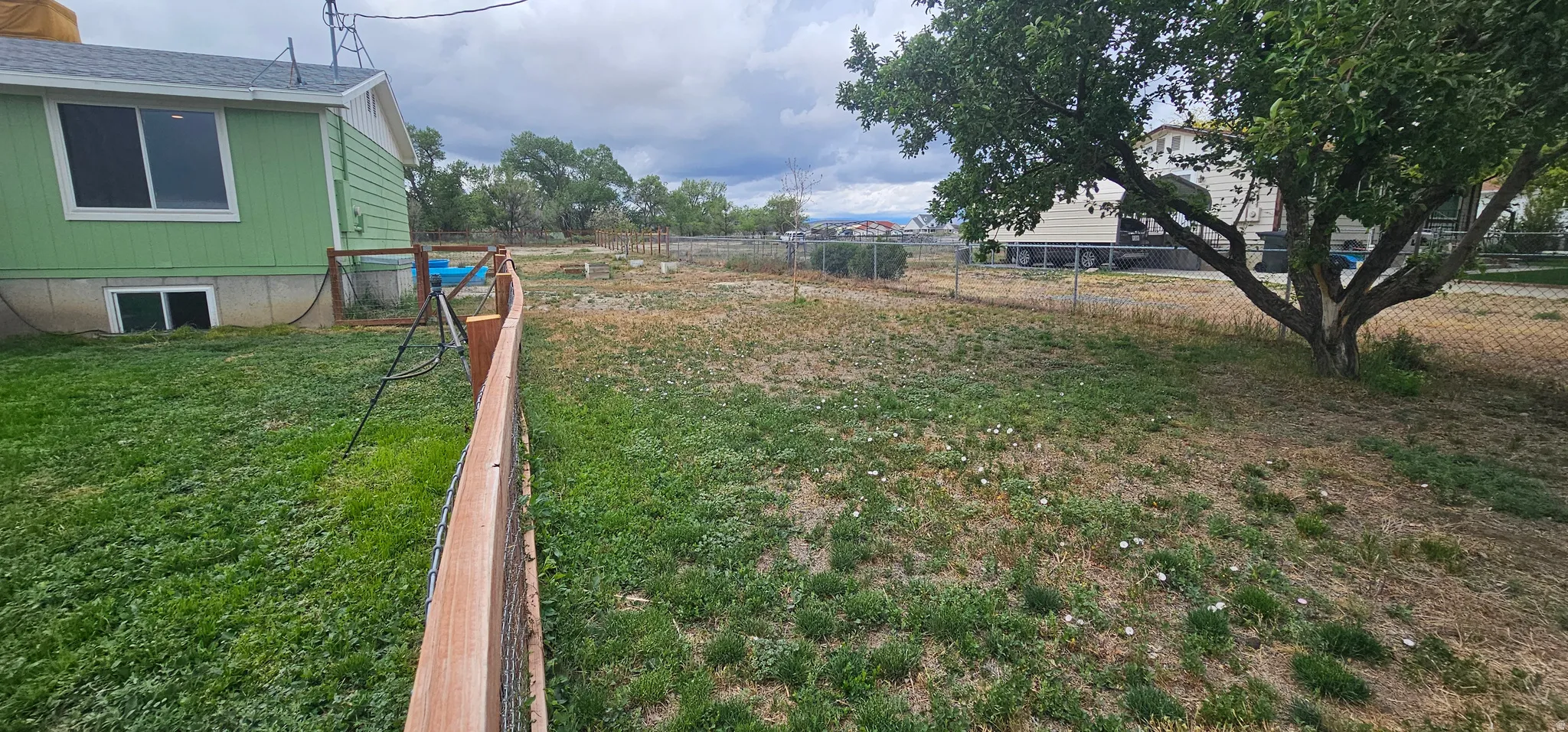 Expansive fenced yard with a combination of wood and chain-link fencing
