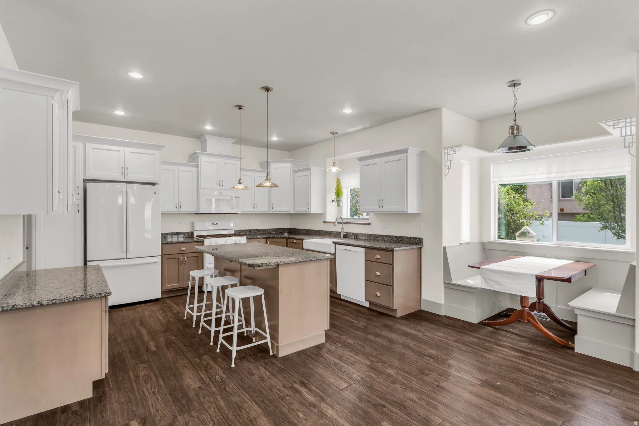 Spacious kitchen featuring wood-finish flooring and recessed lighting