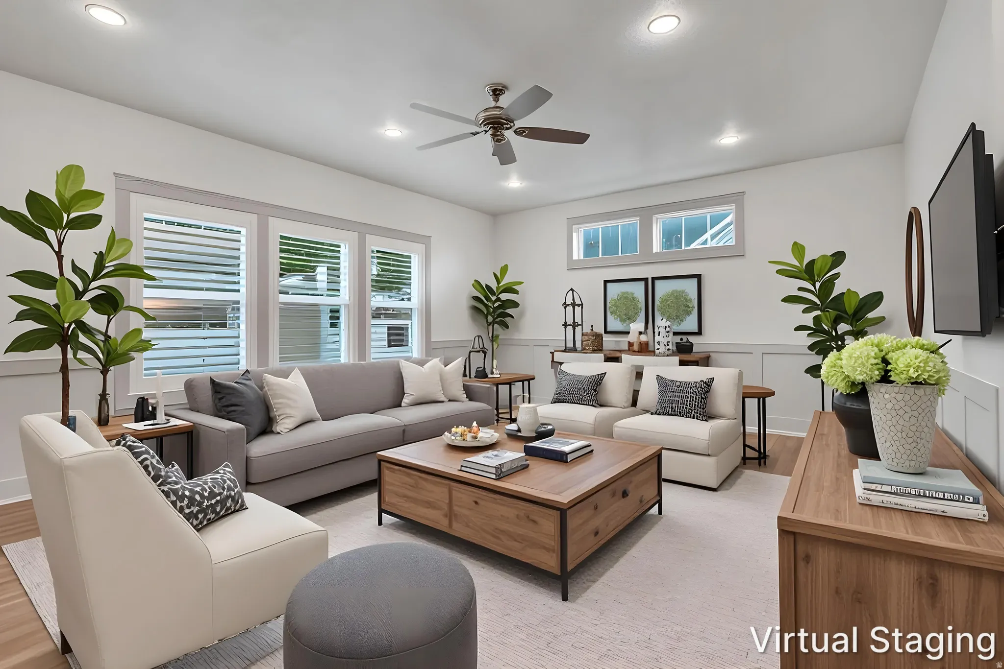 Spacious living area featuring recessed lighting, a ceiling fan, multiple windows with blinds, and wainscoting