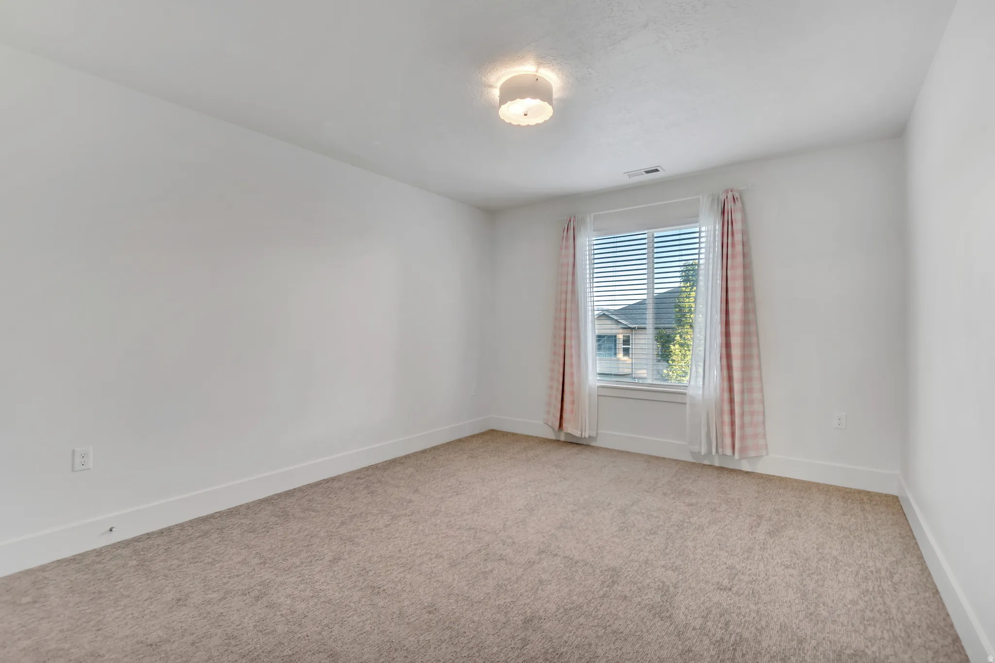 Room featuring wall-to-wall carpeting and white baseboards