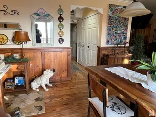 Wood-finish flooring throughout, complemented by wood paneling and neutral wall tones