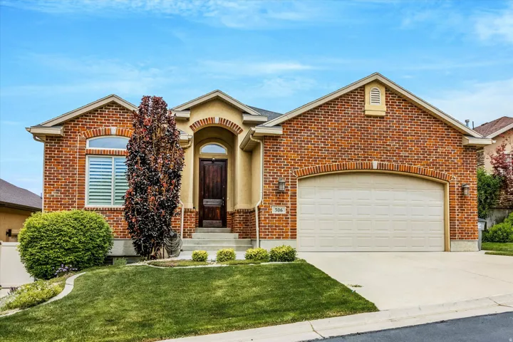 Brick and stucco facade with an arched entry