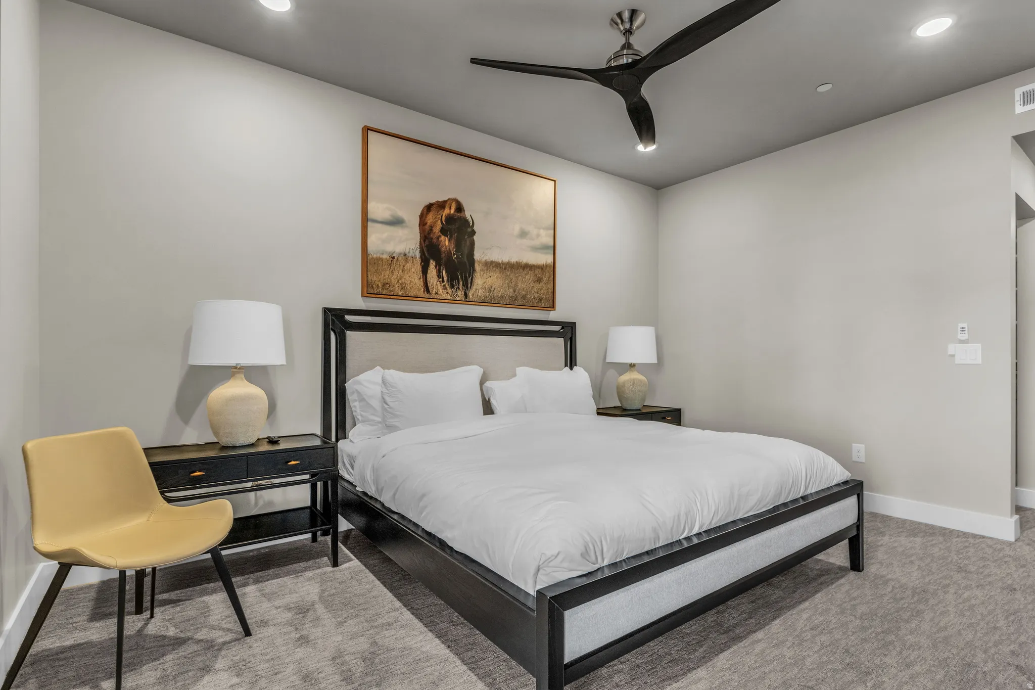 Carpeted room featuring a ceiling fan with integrated lighting, recessed ceiling lights, and light gray wall paint