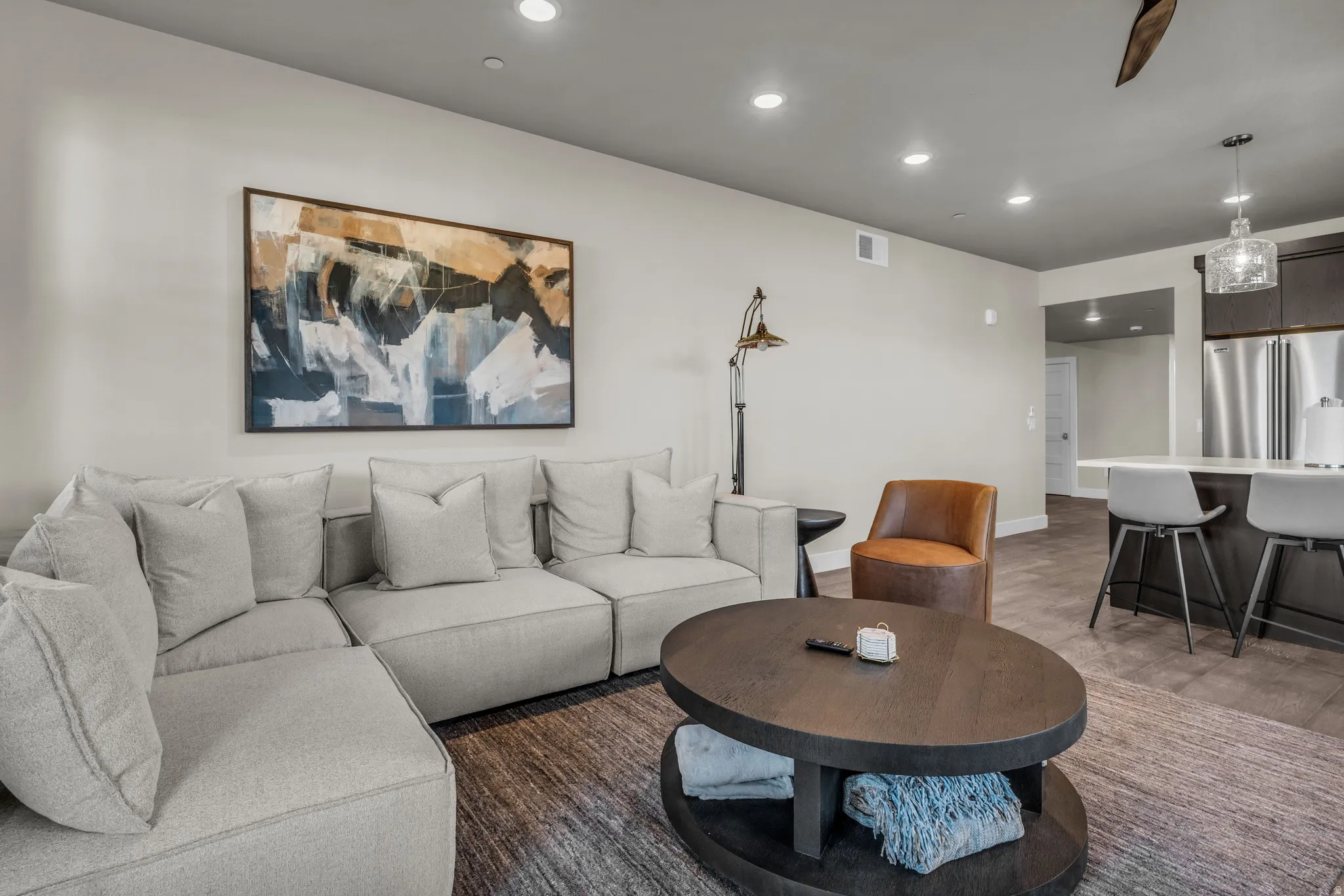 Open-concept living space featuring recessed lighting, light-toned walls, and wood-finish flooring