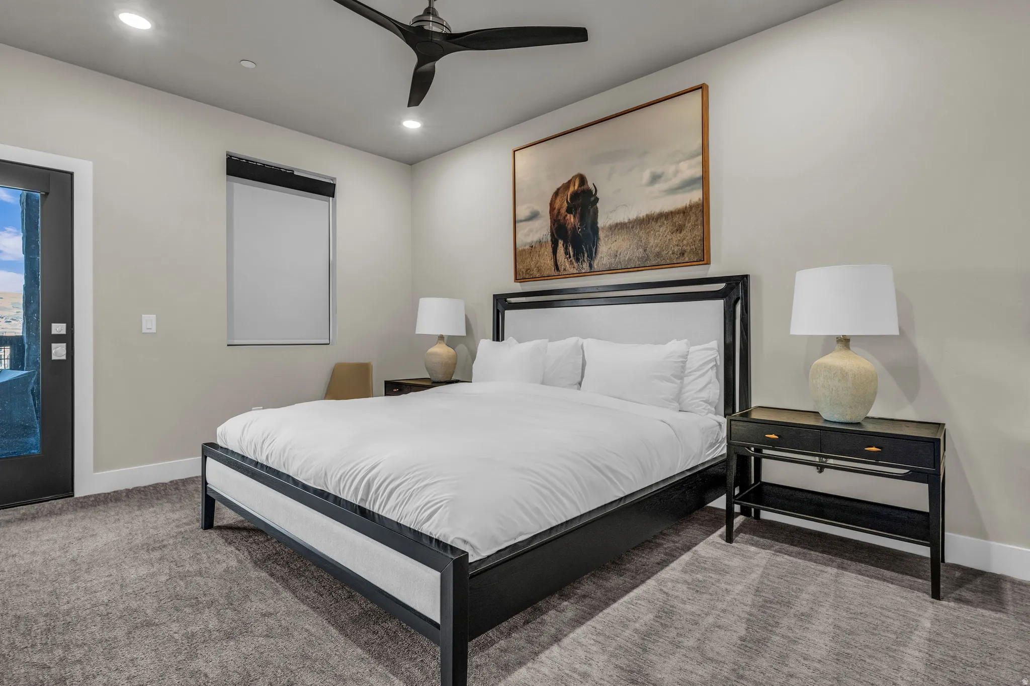 Carpeted room featuring a ceiling fan with recessed lighting, an exterior door with glass panels, and a window with blinds