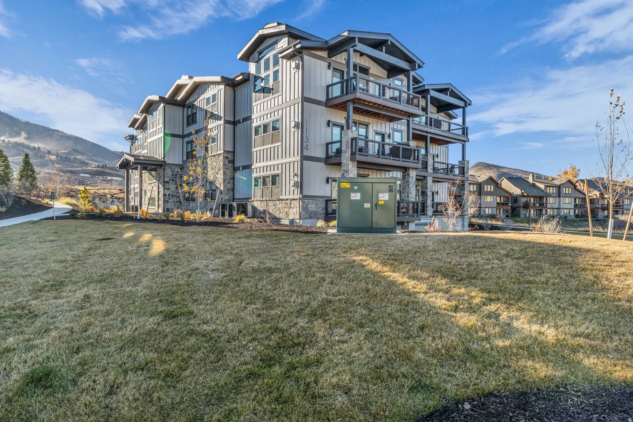 Contemporary multi-story exterior with vertical siding and stone accents