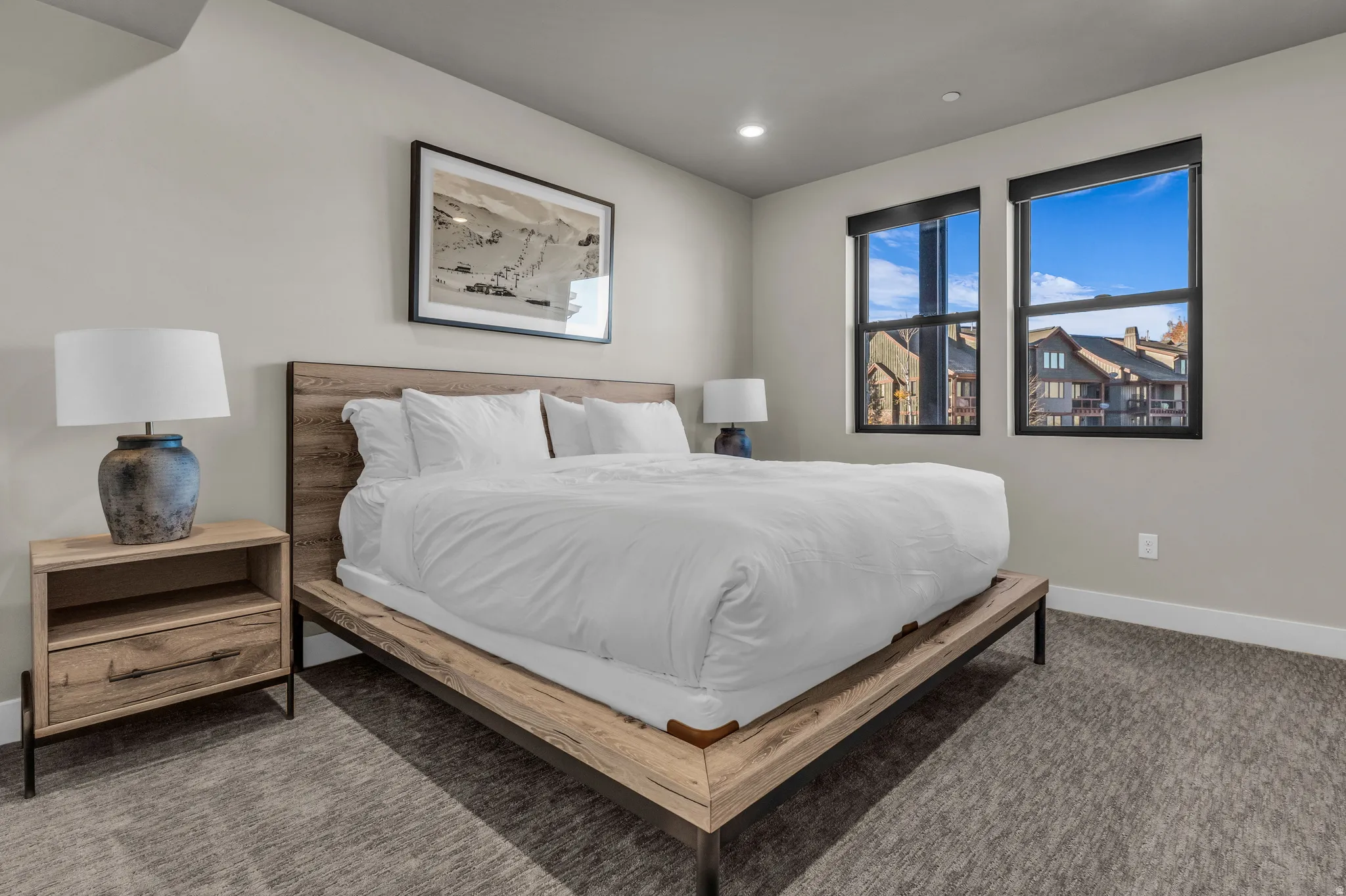 Spacious room featuring neutral-toned walls, recessed lighting, and soft carpet flooring