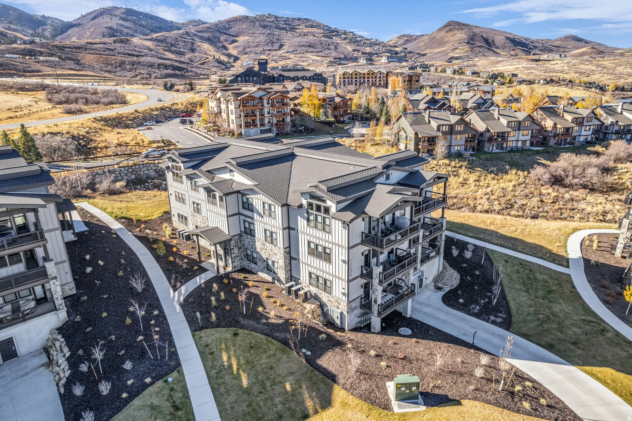 Modern multi-story building featuring stone and siding exterior finishes