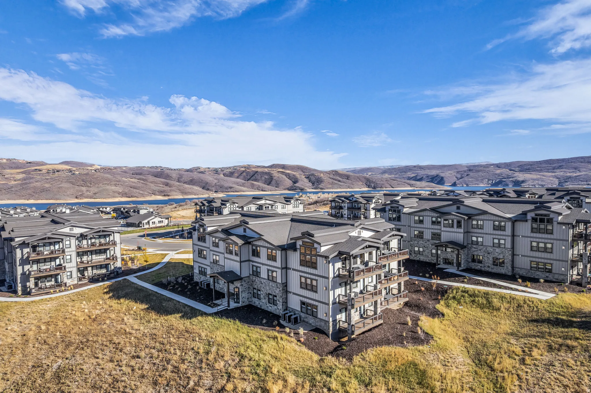 Modern residential buildings with multi-level balconies and dark-pitched roofs