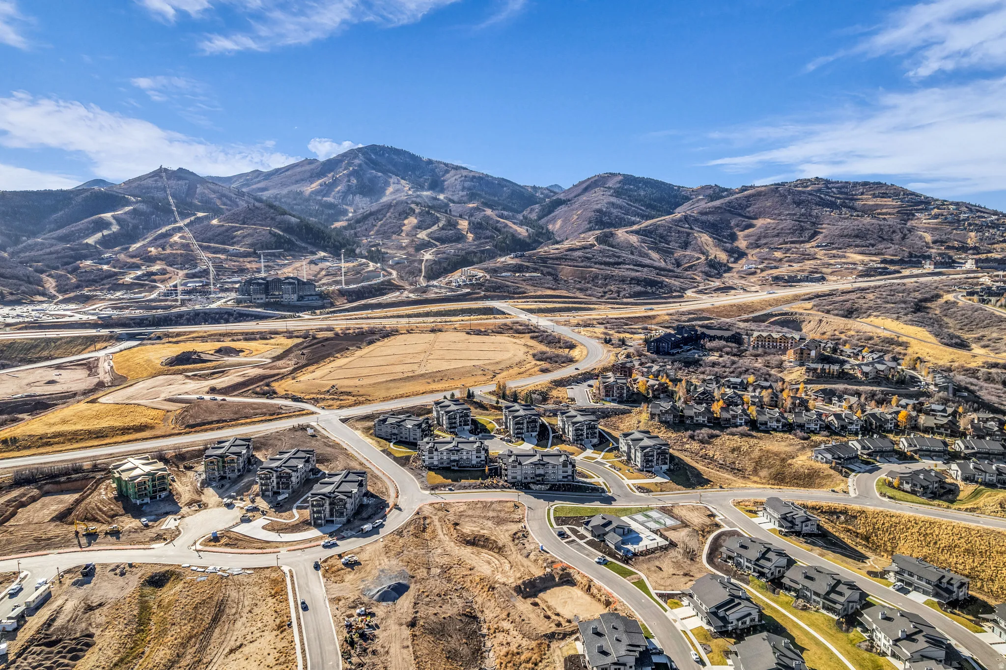 Expansive mountain scenery framing a developing residential area with modern multi-story structures