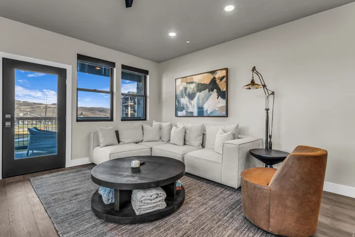 Living area featuring wood-finish flooring, light neutral wall paint, and recessed ceiling lighting
