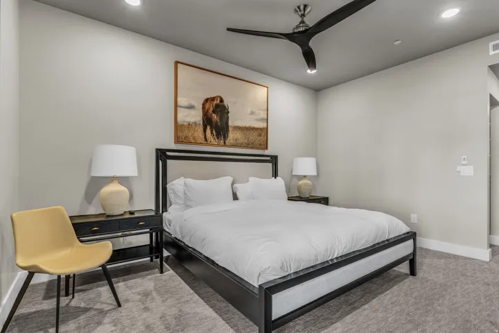 Carpeted room featuring a ceiling fan with integrated lighting, recessed ceiling lights, and light gray wall paint