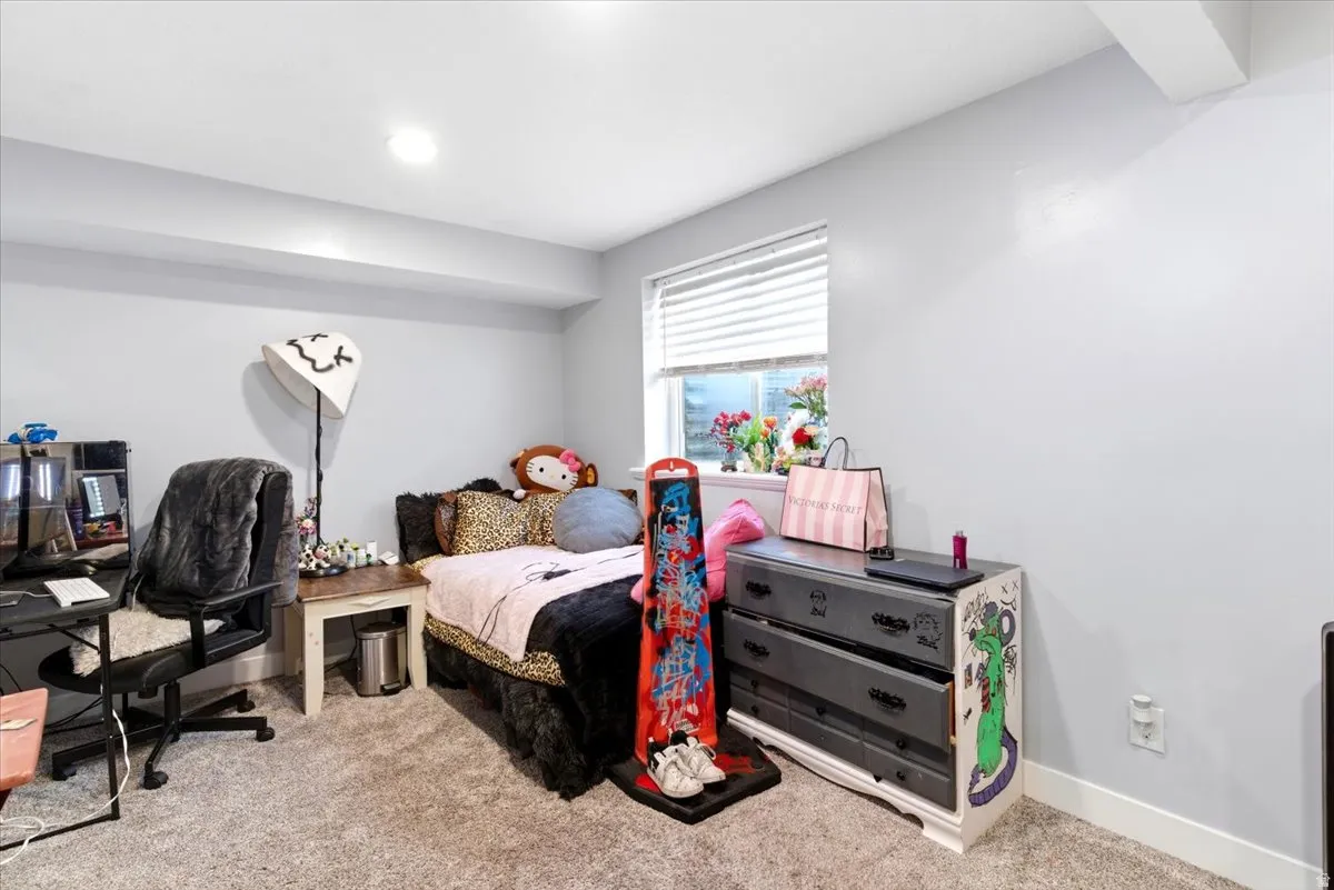 Carpeted room with light grey walls and a single window featuring blinds