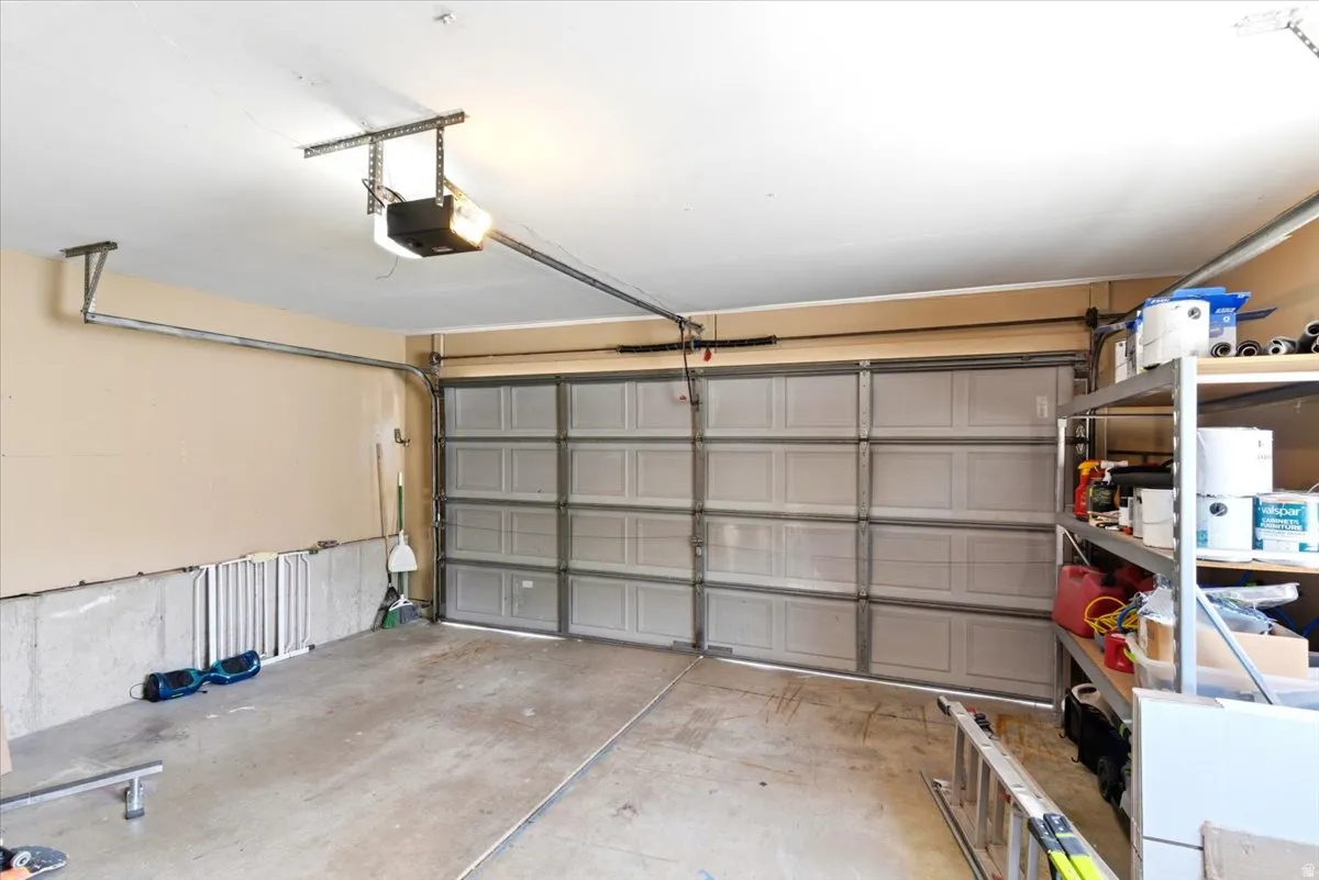 Spacious garage featuring a concrete floor, light beige walls, and a sectional garage door