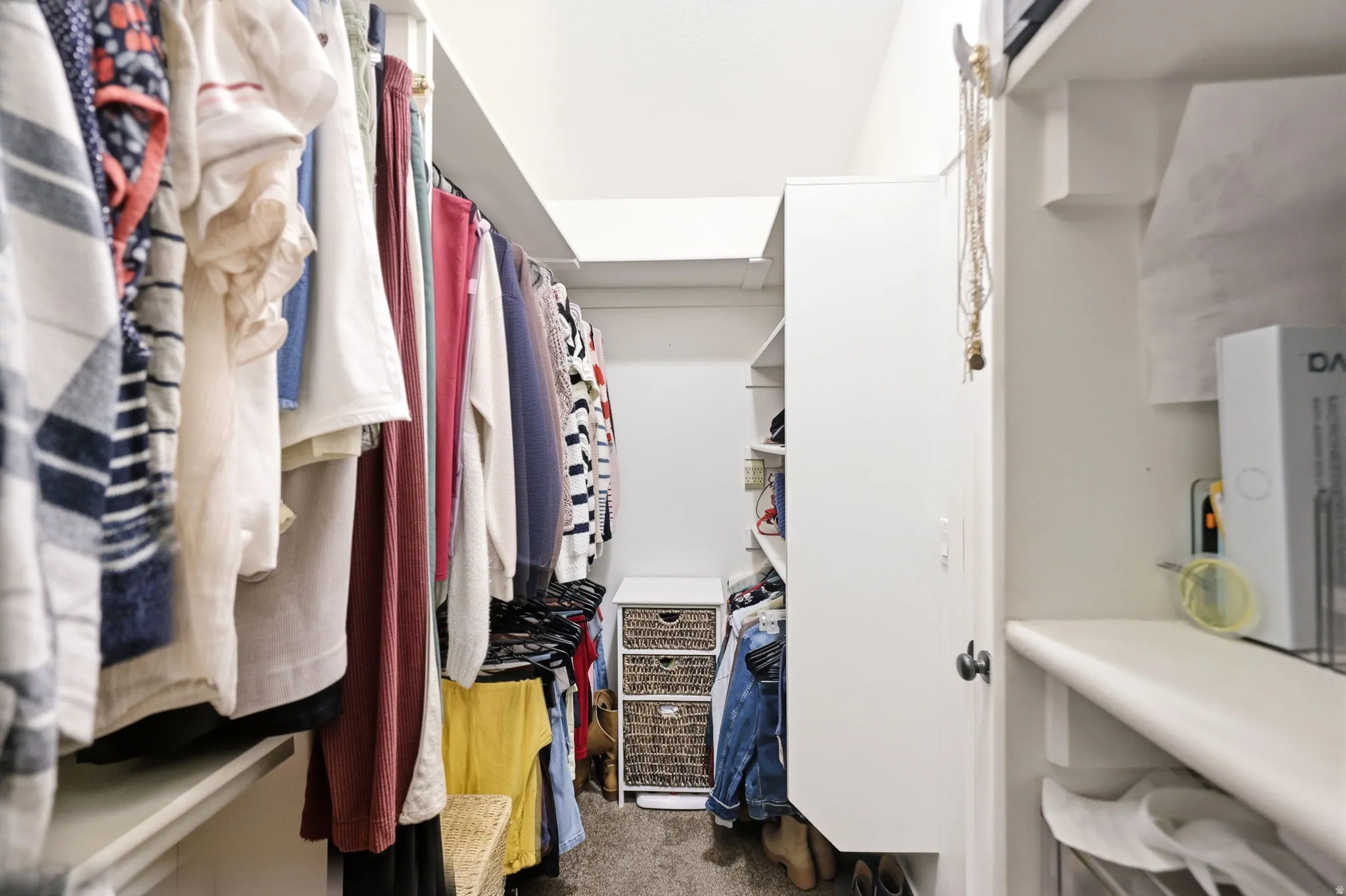 Walk-in closet featuring built-in shelving, hanging rods, and integrated storage solutions