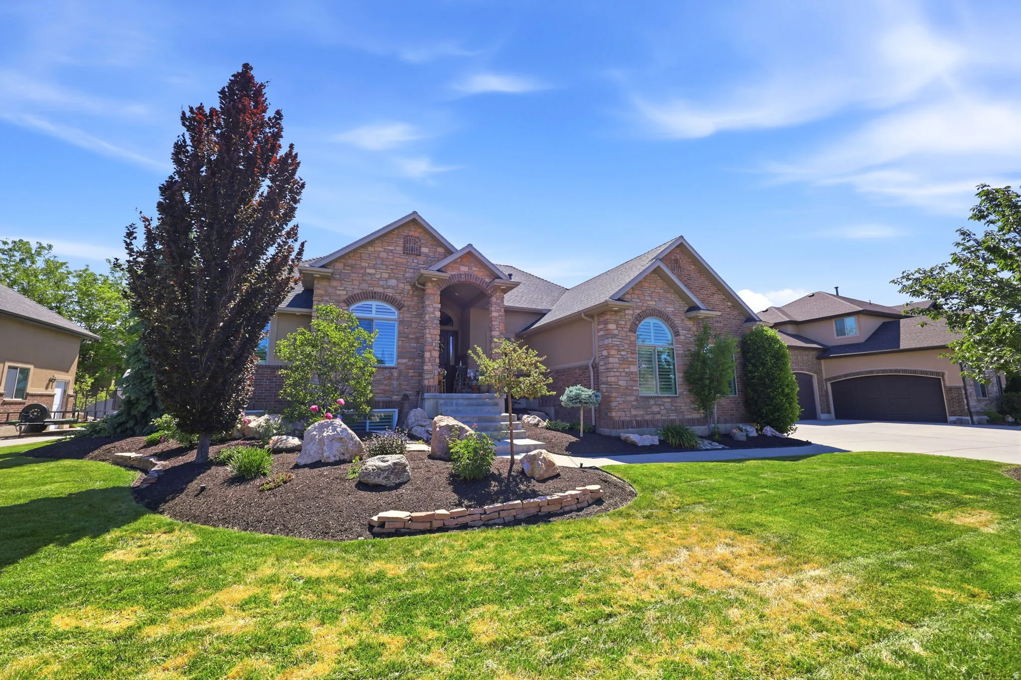 Stone and stucco exterior with arched entryways