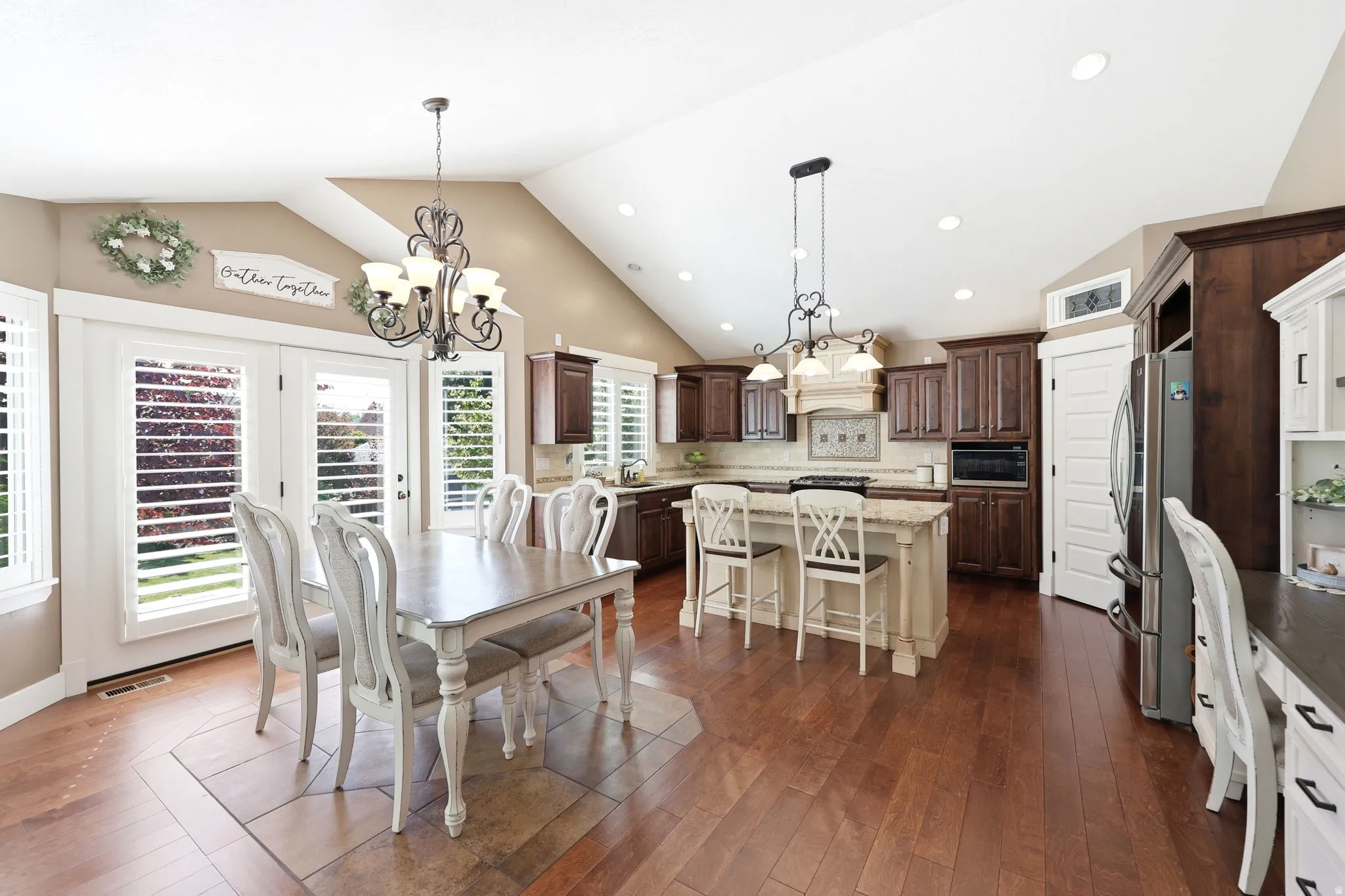 Open-concept kitchen and dining area featuring vaulted ceilings