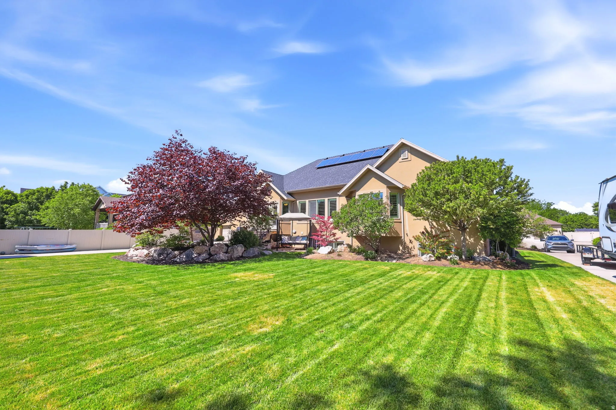 Expansive rear yard featuring a manicured lawn