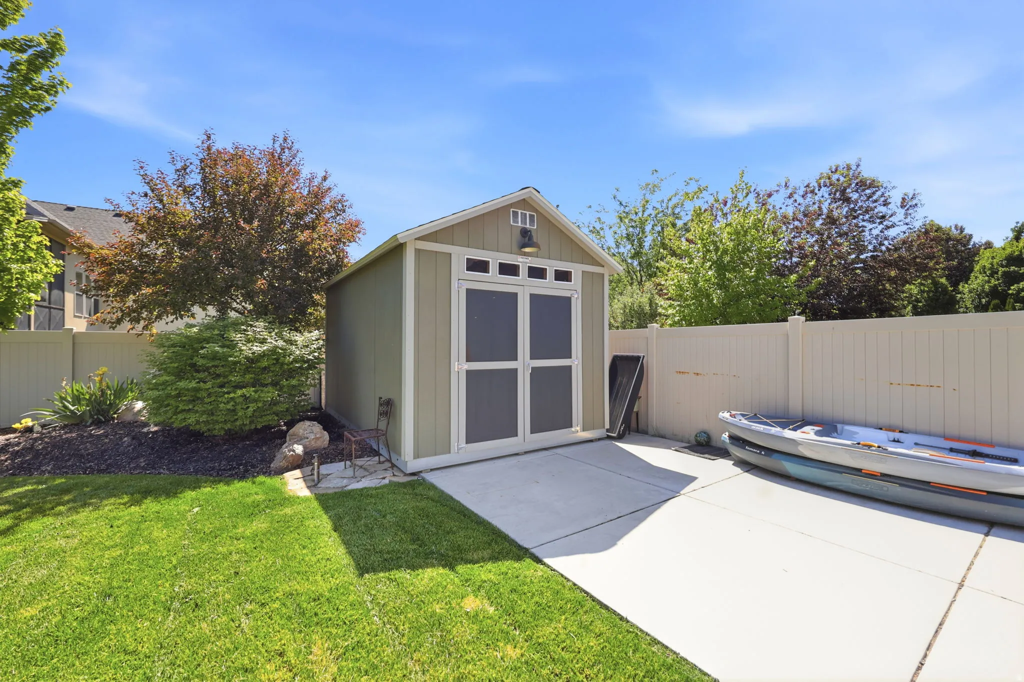 Backyard shed with double doors and transom windows