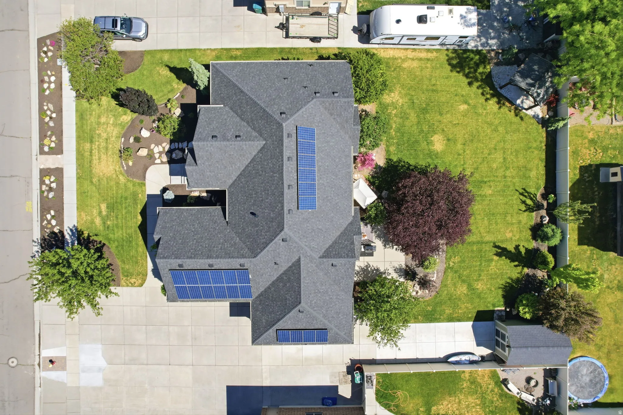 Asphalt shingle roof with multiple solar panel arrays