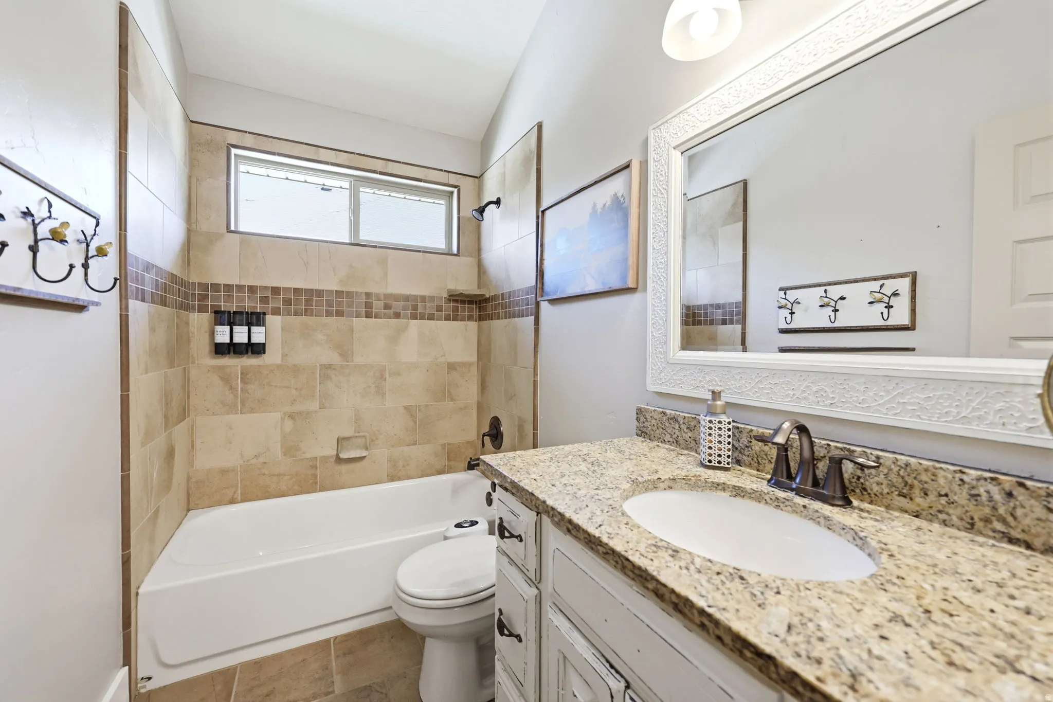 Bathroom vanity featuring a light-toned granite countertop, undermount sink, and oil-rubbed bronze faucet